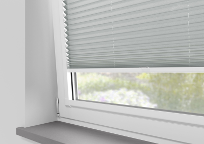 Light grey window blinds partially closed