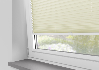 Light yellow window blinds partially closed