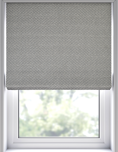 Gray patterned roller blind covering window